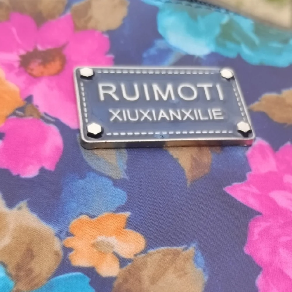 RUIMOTI Floral Crossbody Bag in Navy with Pink & Blue Flowers - Picture 2 of 6